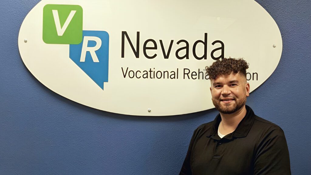 Chris Jarvis Smiles in front of VR Nevada Sign