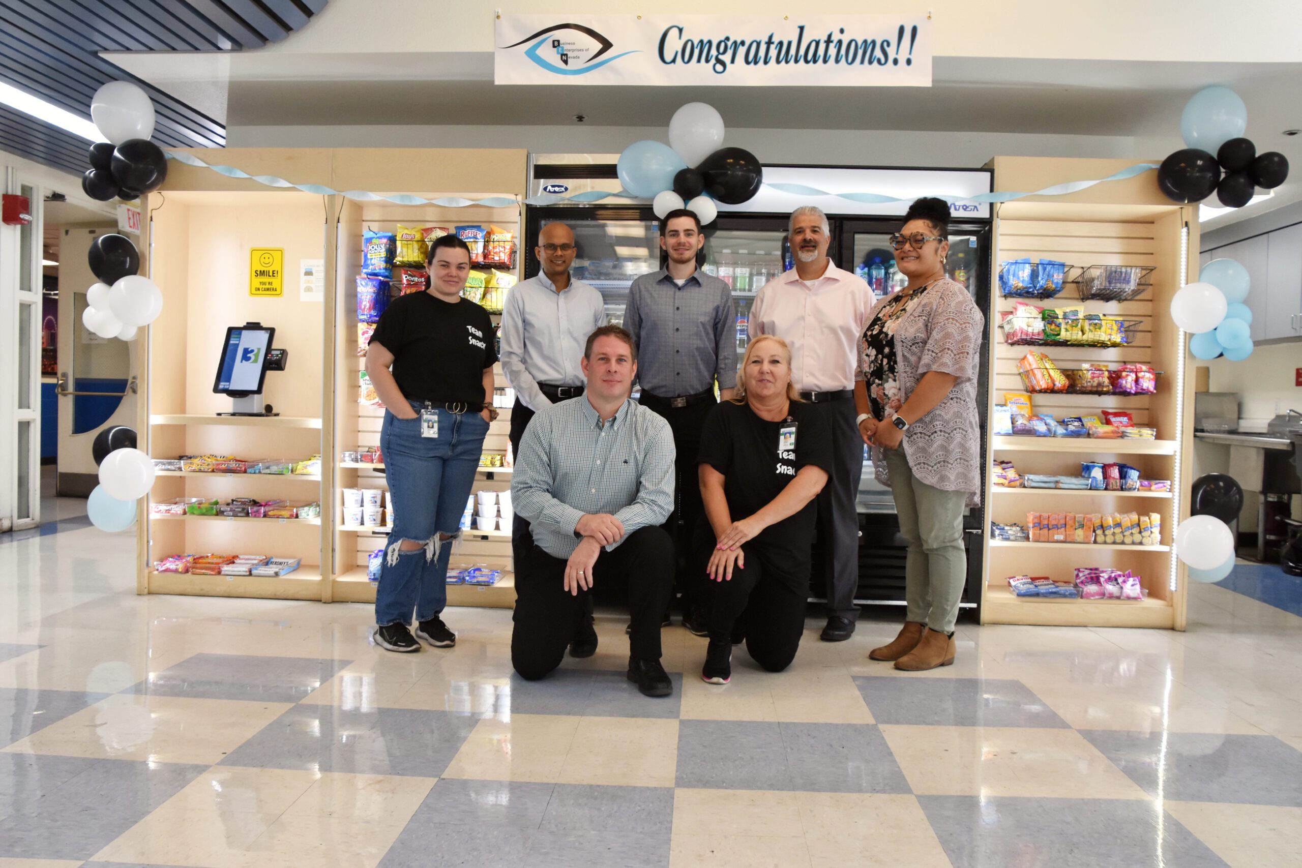 The BEN Staff pose in front of the snack-a-licious counter