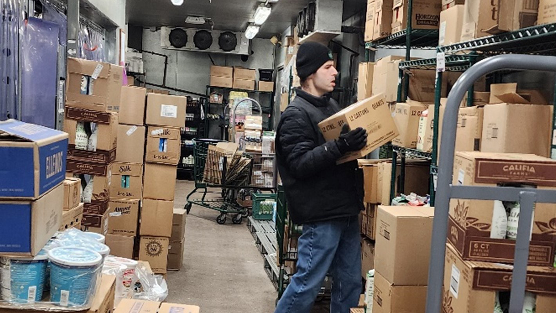 mitchell stacks boxes at a whole foods