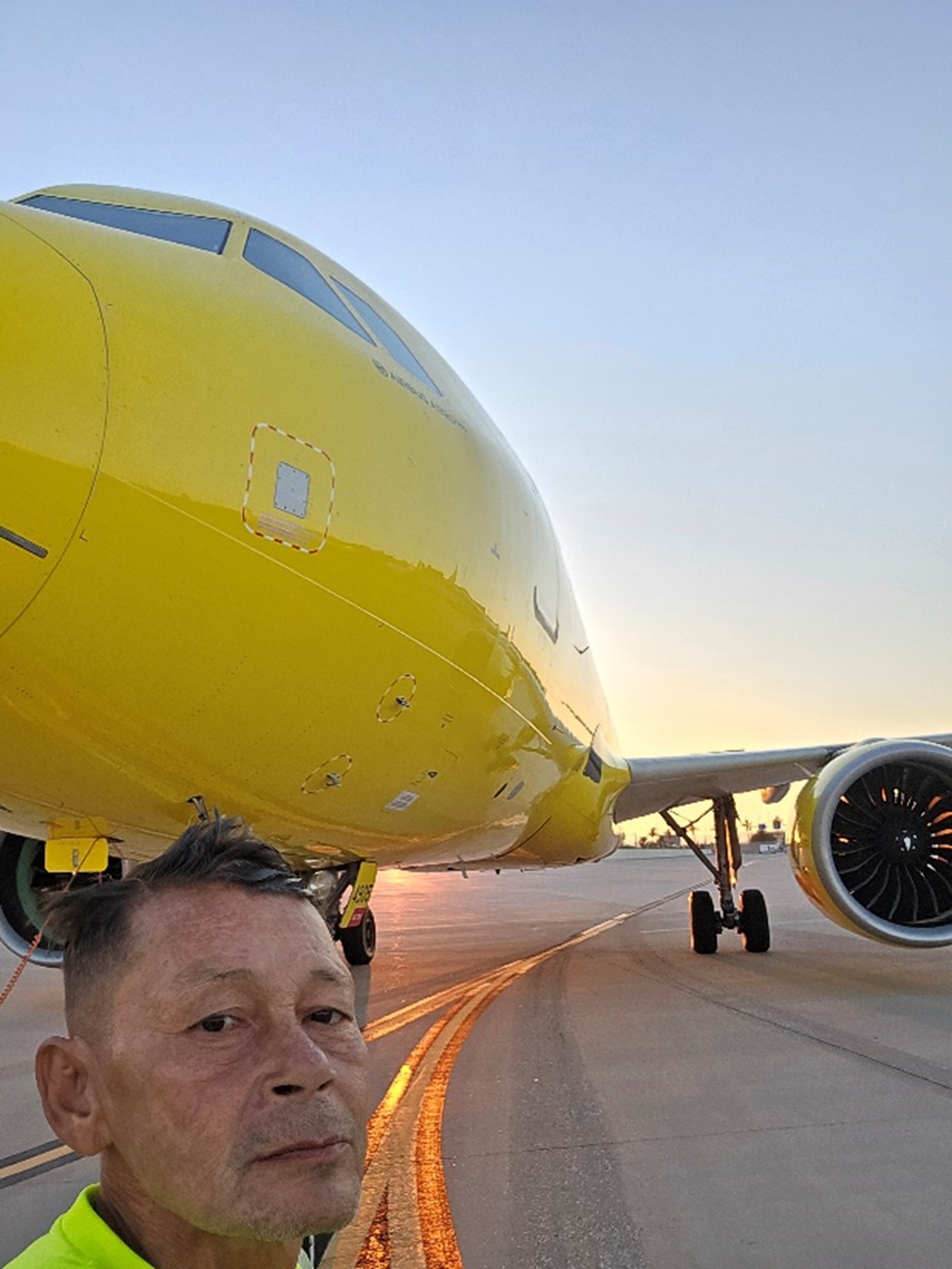 walter poses in front of a 737 on the tarmac