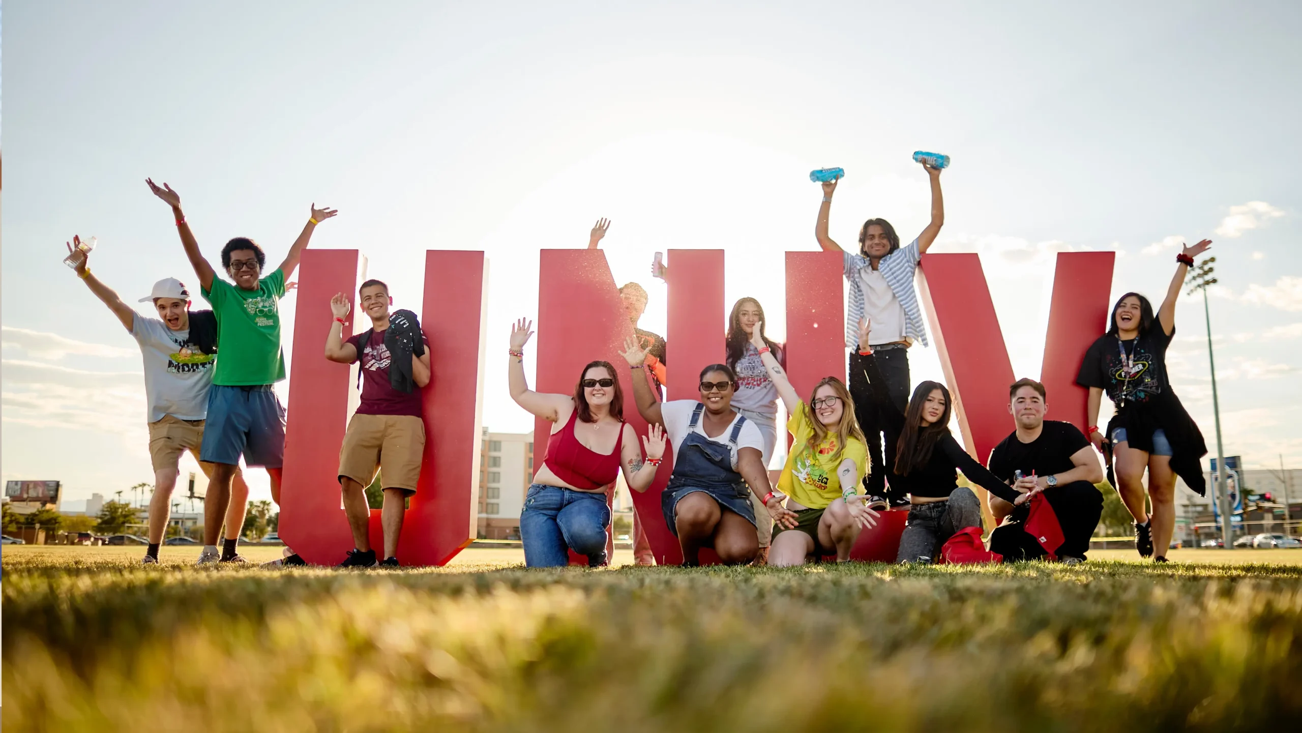 a diverse group pose with the unlv sign